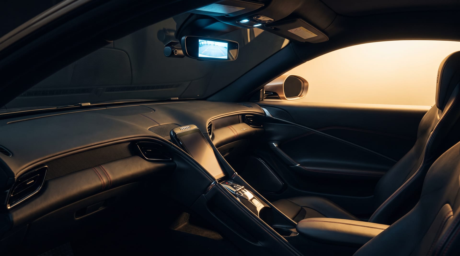 Hidden wiring behind the dashboard of a sports car during the installation of electronics