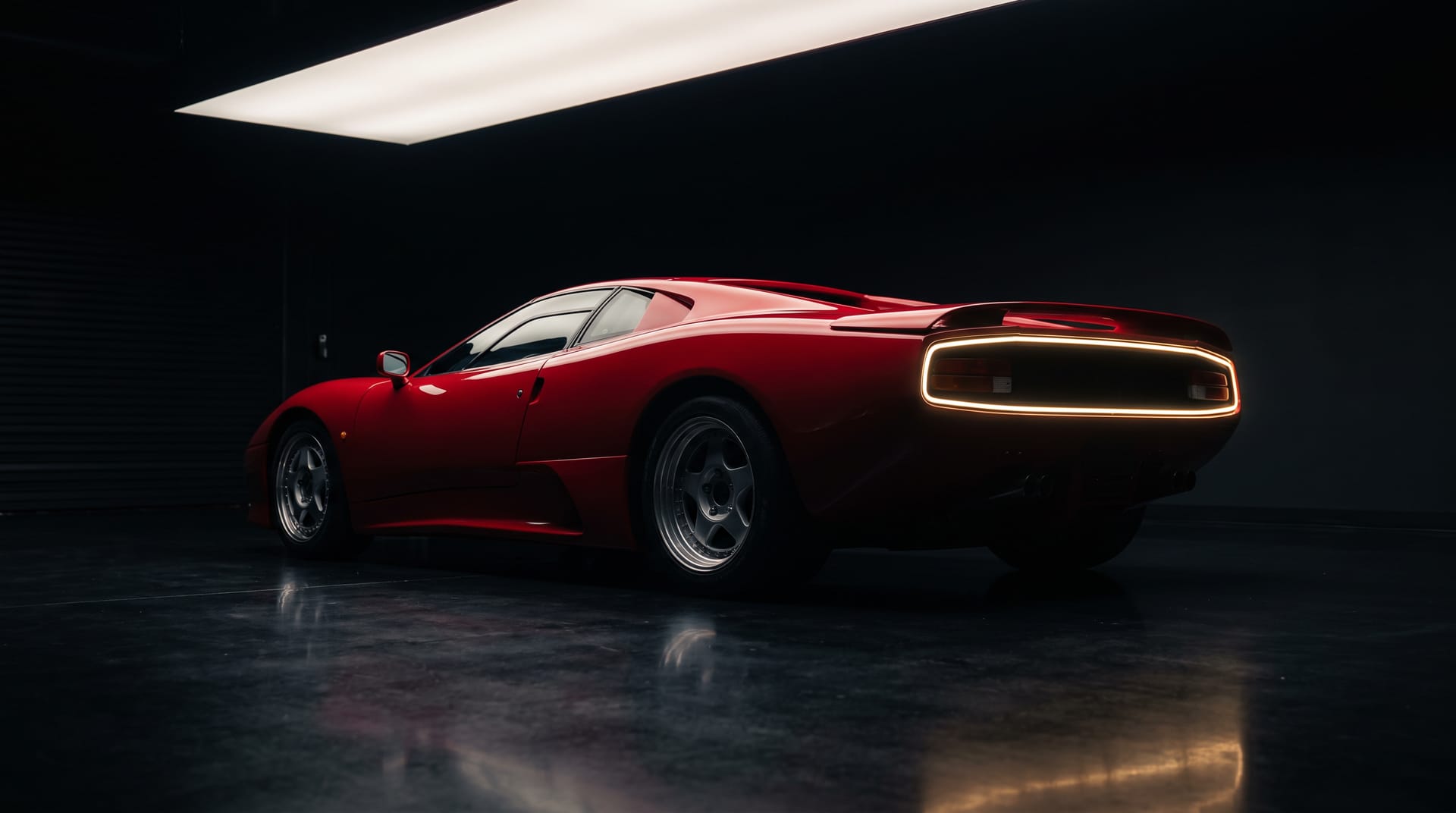 Red supercar with Paint Protection Film on the front end, photographed under studio lighting