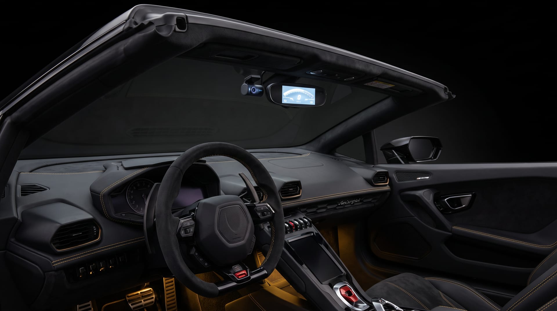 Dashboard of a Ferrari with a dashcam discreetly mounted behind the rear-view mirror